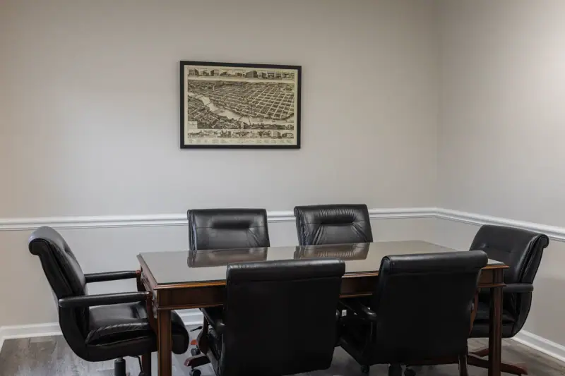 Group room at River City Recovery with a round wood table and chairs